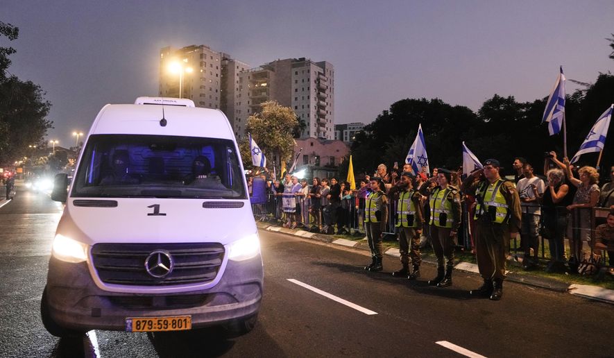 A convoy carrying a coffin handed over to Israel from Gaza arrives at the Abu Kabir Forensic Institute in Tel Aviv, Israel, Sunday, Nov. 9, 2025. Hamas claims the coffin contains the remains of Hadar Goldin, an Israeli soldier killed in Gaza in 2014 and whose body has been held in Gaza since. (AP Photo/Mahmoud Illean)