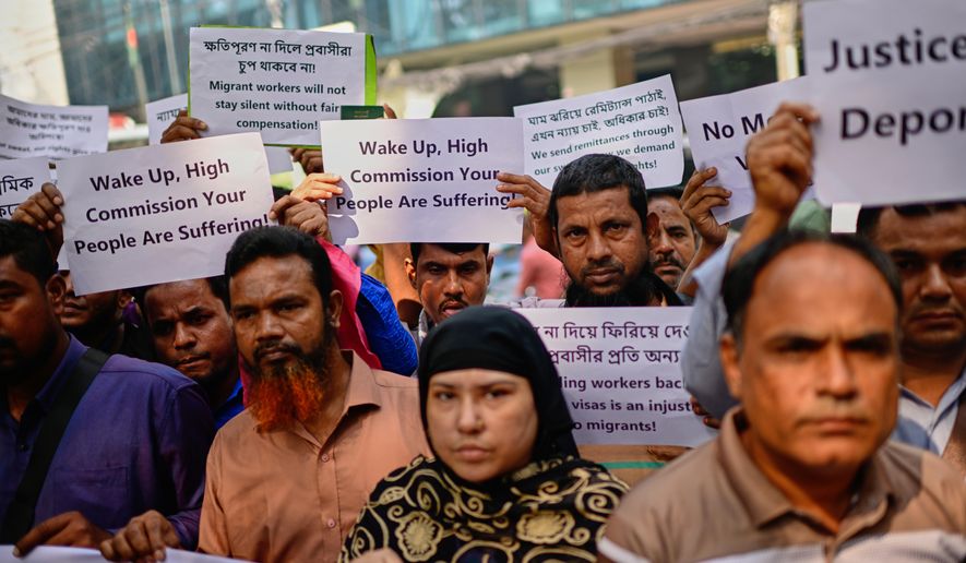 Bangladeshi workers who were employed by Malaysian companies protest in front of the Ministry of Expatriates' Welfare and Overseas Employment demanding unpaid wages, fair compensation and an end to alleged abuse by Malaysian employers, in Dhaka, Bangladesh, Monday, Nov. 10, 2025. (AP Photo/Mahmud Hossain Opu)