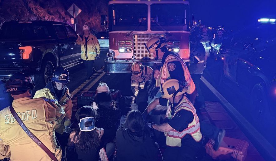 This image provided by San Bernardino County Fire shows the scene on a highway near Running Springs, Calif., where a bus overturned on Sunday, Nov. 9, 2025. (San Bernadino County Fire via AP