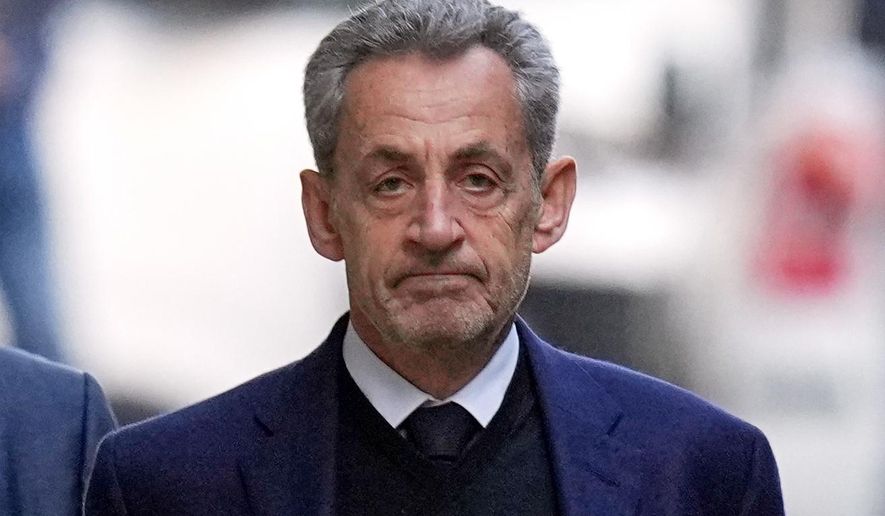 Former French President Nicolas Sarkozy leaves his home Tuesday, Oct. 21, 2025 in Paris as he heads to prison to serve time for a criminal conspiracy to finance his 2007 election campaign with funds from Libya. (AP Photo/Thibault Camus, File)