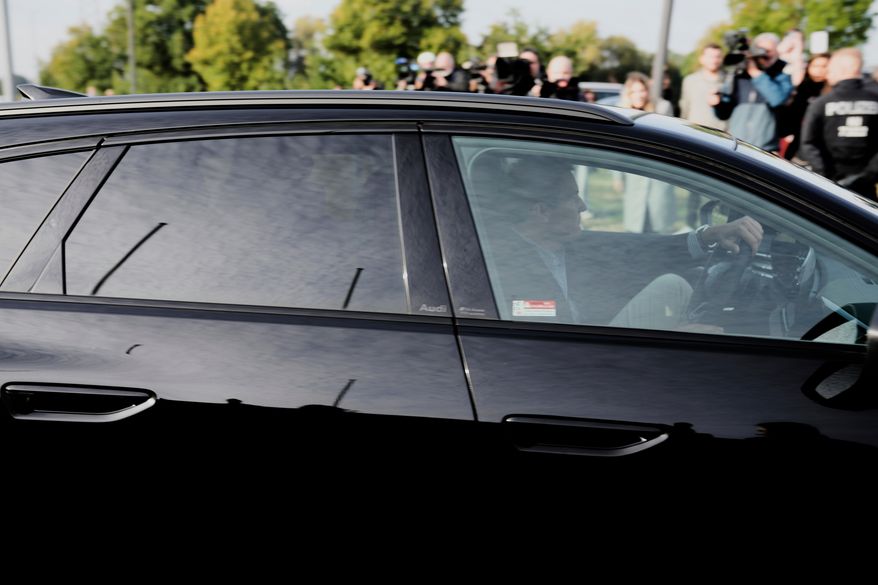 FILE - Lawyer Friedrich Fuelscher leaves the prison in a black car carrying Christian B., a suspect in the 2007 disappearance of British toddler Madeleine McCann, as he sits in the back seat behind tinted windows in Sehnde, Germany, Wednesday, Sept. 17, 2025. (AP Photo/Markus Schreiber, File)