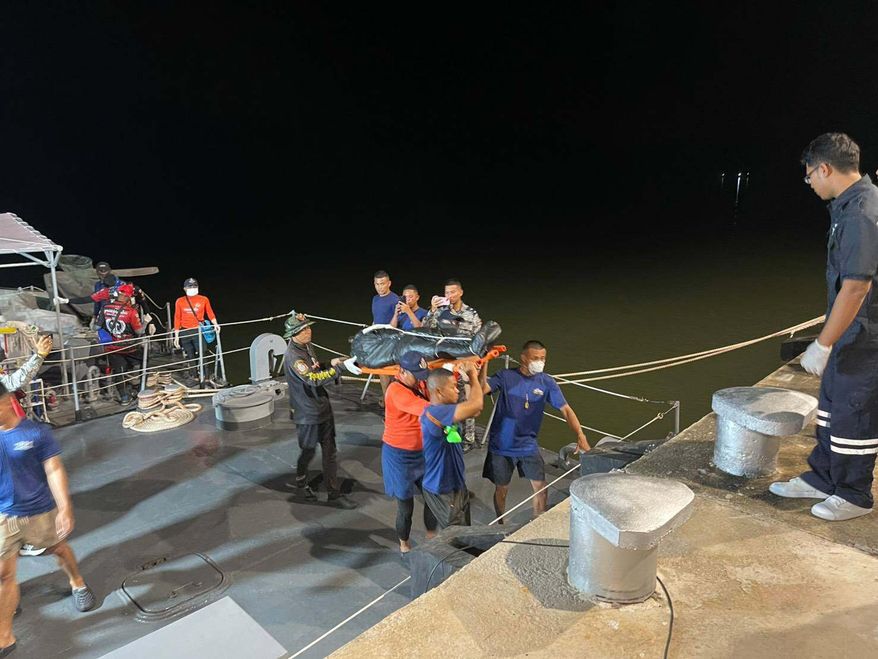 In this image released by Romsai Rescue Foundation Satun, Thai Navy carry a body which is believed to be one of passengers from a boat that believed sank near Tarutao island, Satun, southern Thailand, Sunday, Nov. 9, 2025. (Romsai Rescue Foundation Satun via AP)