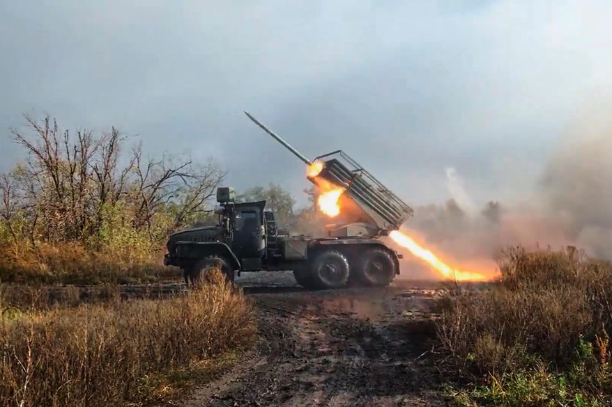 In this image made from video provided by Russian Defense Ministry Press Service on Friday, Nov. 7, 2025, a Russian "Grad" self-propelled 122 mm multiple rocket launcher fires towards Ukrainian positions on an undisclosed location in Ukraine. (Russian Defense Ministry Press Service via AP)