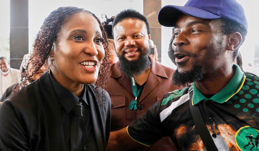 Duduzile Zuma-Sambudla, daughter of former South African president Jacob Zuma, left, shares a light moment outside High Court during her trial for terrorism linked to the July 2021 riots in Durban, South Africa, Monday, Nov. 10, 2025. (AP Photo)