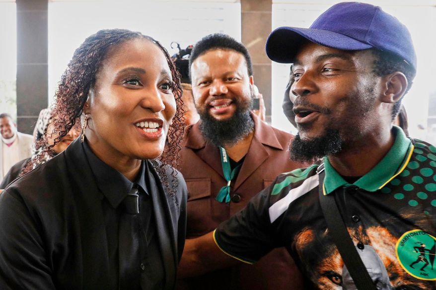 Duduzile Zuma-Sambudla, daughter of former South African president Jacob Zuma, left, shares a light moment outside High Court during her trial for terrorism linked to the July 2021 riots in Durban, South Africa, Monday, Nov. 10, 2025. (AP Photo)
