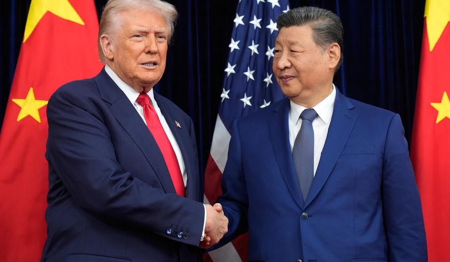 President Donald Trump, left, and Chinese President Xi Jinping shake hands before their meeting ahead of their summit talk at Gimhae International Airport in Busan, South Korea, Thursday, Oct. 30, 2025. (AP Photo/Mark Schiefelbein)