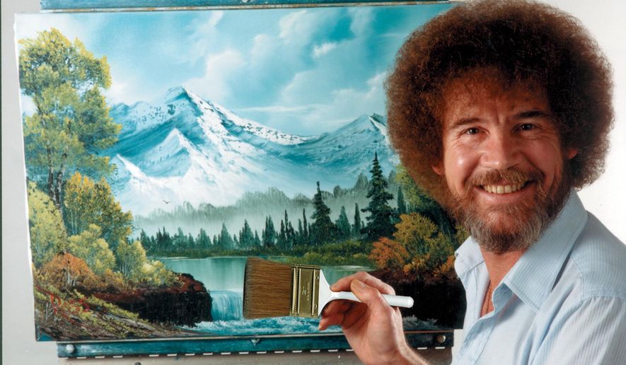 In this undated photo provided by Bob Ross Inc., Bob Ross poses for a photo in front of one of his paintings. (Bob Ross Inc. via AP)