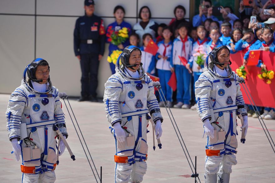 Chinese astronaut for the Shenzhou 20 mission, Chen Dong, center, speaks next to his comrades Chen Zhongrui, right, and Wang Jie as they attend a send-off ceremony for their manned space mission at the Jiuquan Satellite Launch Center in northwestern China, Thursday, April 24, 2025. (AP Photo/Andy Wong, File)