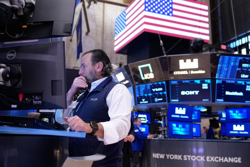Michael Pistillo works on the floor at the New York Stock Exchange in New York, Tuesday, Nov. 11, 2025. (AP Photo/Seth Wenig)