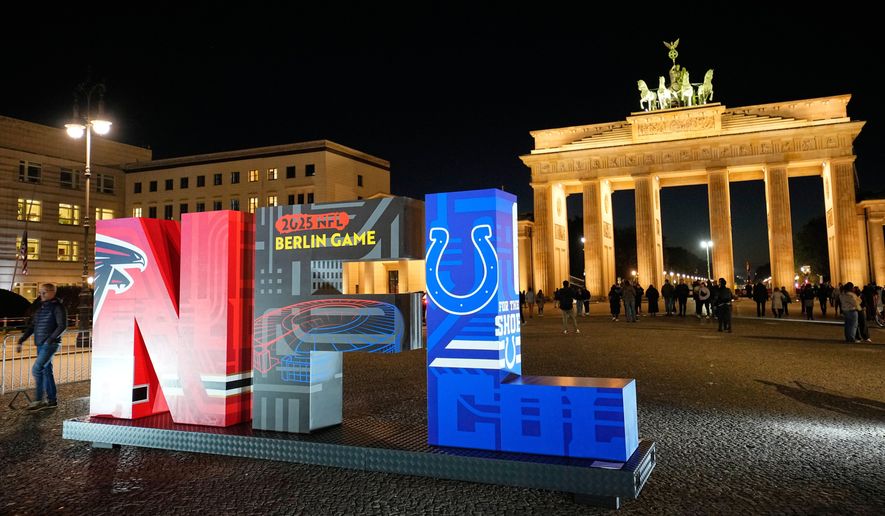 The NFL logo is illuminated in front of the Brandenburg Gate in Berlin, Germany, Thursday, Nov. 6, 2025, during an event promoting the NFL ahead of the upcoming game between the Indianapolis Colts and the Atlanta Falcons. (AP Photo/Martin Meissner)