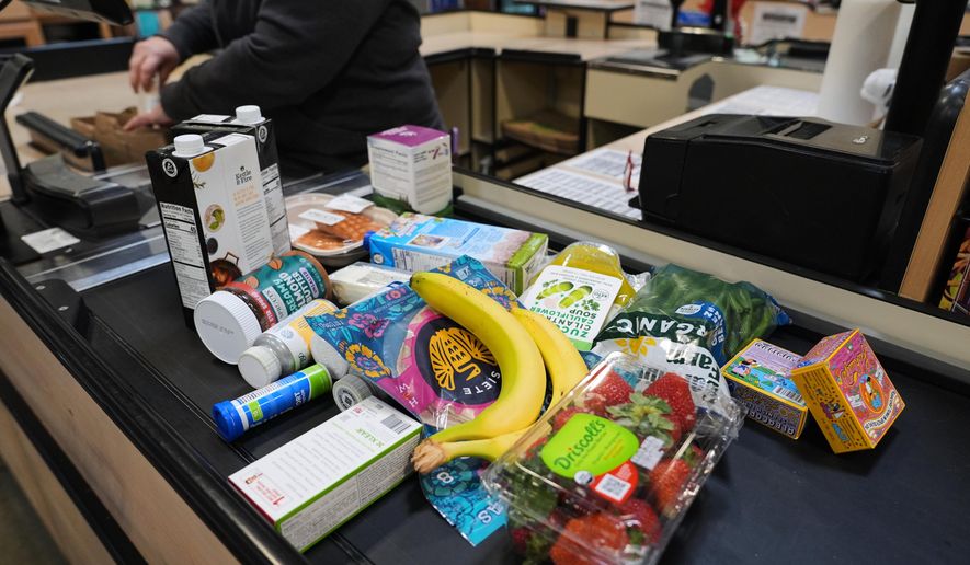 A cashier scans groceries, including produce, which is covered by the USDA Supplemental Nutrition Assistance Program (SNAP), at a grocery store in Baltimore, Monday, Nov. 10, 2025. (AP Photo/Stephanie Scarbrough)
