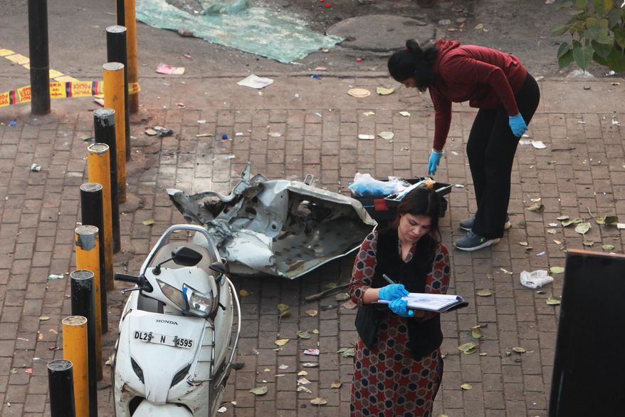 Investigators examine the site of Monday's car explosion near the historic Red Fort, in New Delhi, India, Tuesday, Nov. 11, 2025. (AP Photo)