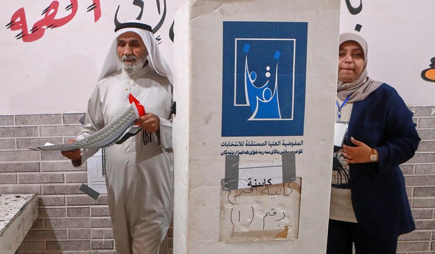 Iraqis voters gather to cast their vote at a ballot station in the country's parliamentary election in Basra, Iraq, Tuesday, Nov. 11, 2025. (AP Photo/Ali Rahim)