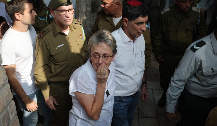 Leah and Simcha Goldin, the parents of late Israeli hostage soldier Hadar Goldin, attend his funeral, in Kfar Saba, Israel, Tuesday, Nov. 11, 2025. Goldin was killed in 2014 and his body was returned as part of the current ceasefire deal between Israel and Hamas. (Abir Sultan/Pool Photo via AP)