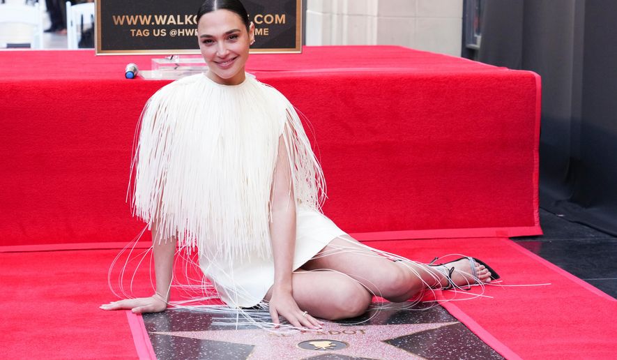 FILE - Gal Gadot poses with her new star at a ceremony honoring her on the Hollywood Walk of Fame on Tuesday, March 18, 2025, in Los Angeles. (Photo by Jordan Strauss/Invision/AP, file)
