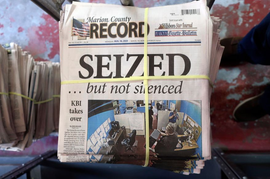 FILE - A stack of the Marion County Record sits in the back of the newspaper's building, awaiting unbundling, sorting and distribution, Aug. 16, 2023, in Marion, Kan. A former reporter for a weekly Kansas newspaper has agreed to accept $235,000 to settle part of her federal lawsuit over a police raid on the paper that made a small town the focus of a national debate over press freedoms. (AP Photo/John Hanna, File)