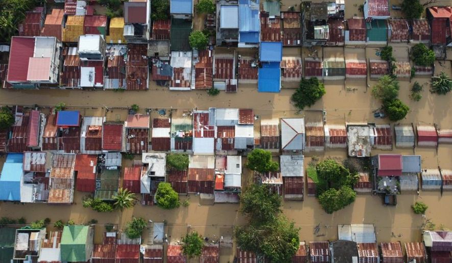 Houses are seen submerged in Ilagan, Isabela province, northern Philippines on Tuesday November 11. 2025 after the onslaught of Typhoon Fung-wong. (AP Photo/Villamor Visaya)