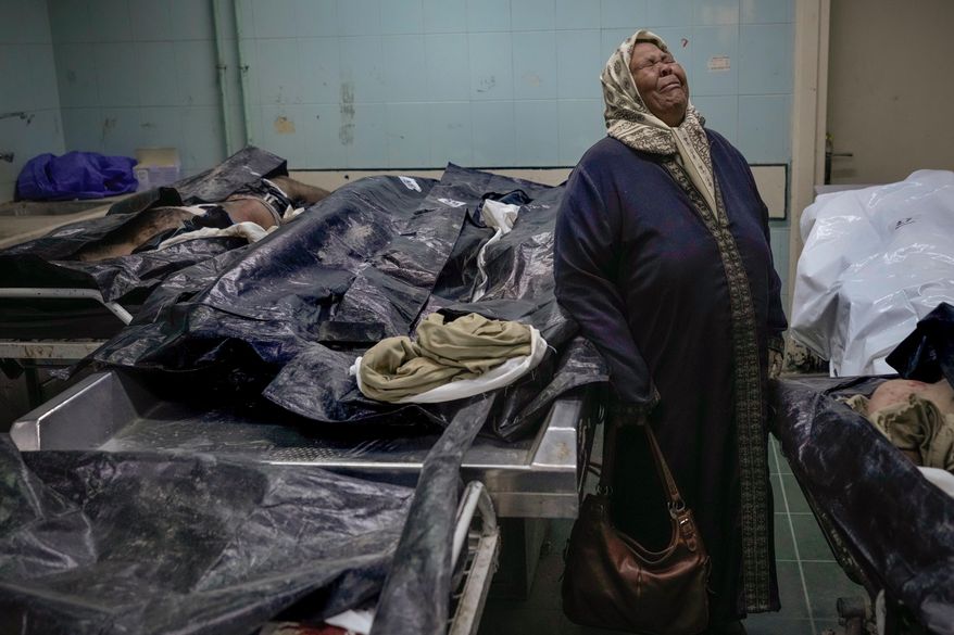 FILE - Hilala Meryeh, a 64-year-old Palestinian mother of four, weeps in the middle of the dingy identification room after finding her son's body at the Al-Mojtahed Hospital morgue in Damascus, Syria, on Wednesday, Dec. 11, 2024. (AP Photo/Hussein Malla, File)