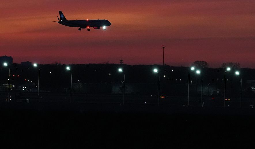 An airplane descends into landing at O'Hare International Airport in Chicago, Wednesday, Nov. 12, 2025. (AP Photo/Nam Y. Huh)