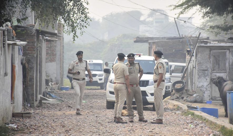 Security officials stand outside a house at Fatehpur Tagga, in Faridabad on the outskirts of New Delhi, India, Monday, Nov. 10, 2025. (AP Photo)