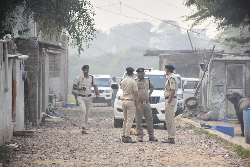 Security officials stand outside a house at Fatehpur Tagga, in Faridabad on the outskirts of New Delhi, India, Monday, Nov. 10, 2025. (AP Photo)