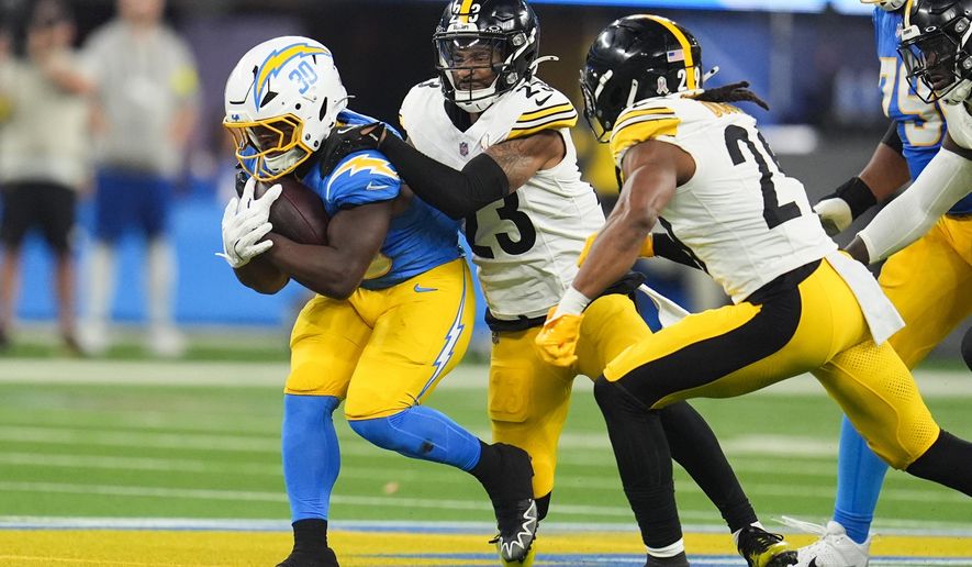 Pittsburgh Steelers cornerback Darius Slay (23) stops Los Angeles Chargers running back Kimani Vidal (30) during the first half of an NFL football game Sunday, Nov. 9, 2025, in Inglewood, Calif. (AP Photo/Marcio Jose Sanchez)