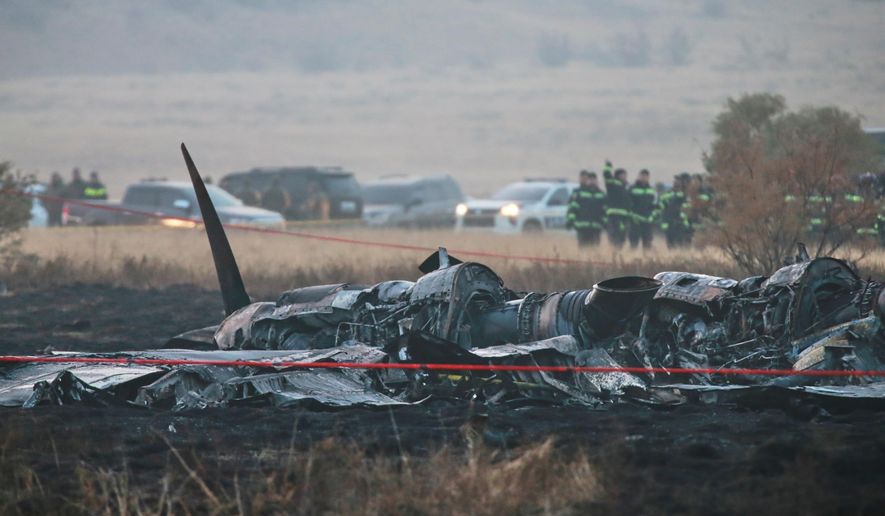 Debris is seen at a crash site of a Turkish military cargo plane in Georgia's Sighnaghi municipality, close to the Azerbaijani border on Wednesday, Nov. 12, 2025. (AP Photo/Zurab Tsertsvadze)