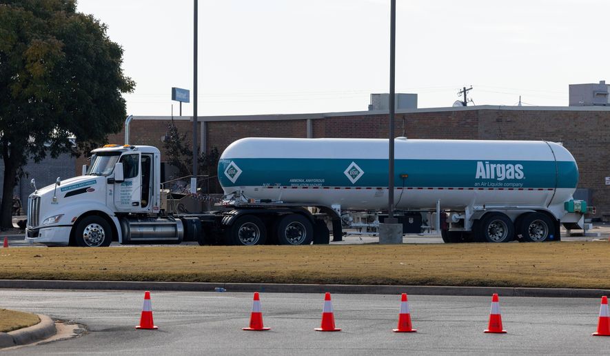 An Airgas semi truck that leaked ammonia sits behind the Holiday Inn Express in Weatherford, Okla. on Thursday, Nov. 13, 2025. (AP Photo/Alonzo Adams)