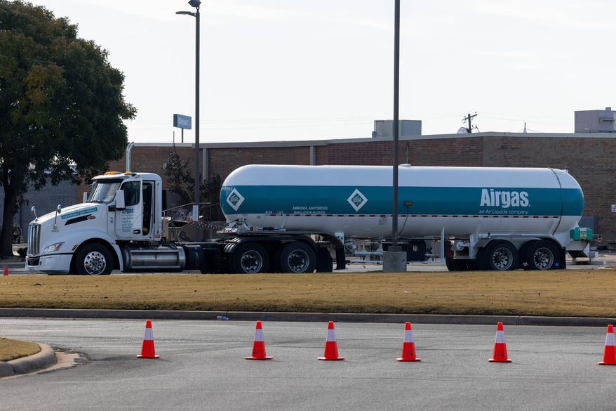 An Airgas semi truck that leaked ammonia sits behind the Holiday Inn Express in Weatherford, Okla. on Thursday, Nov. 13, 2025. (AP Photo/Alonzo Adams)