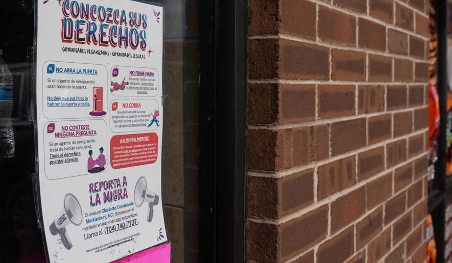 A sign in Spanish that reads at top: "Know Your Rights" is displayed outside of a restaurant store front, Thursday, Nov. 13, 2025, in Charlotte, N.C. (AP Photo/Matt Kelley)