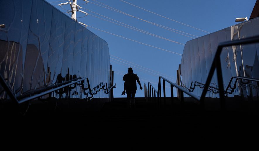 Quantavia Smith walks up the steps of a metro station next to the Santa Monica and Vermont Apartments, where she lives, in Los Angeles, Monday, Nov. 10, 2025. (AP Photo/Jae C. Hong)