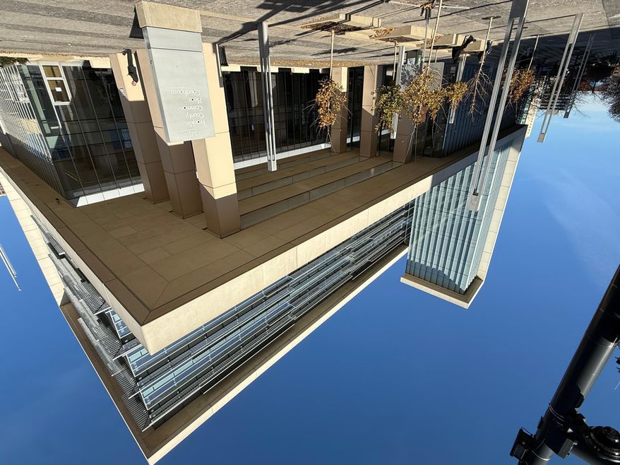 A person stands outside of the Franklin County Common Pleas Courthouse on Thursday, Nov. 13, 2025, in Columbus, Ohio. (AP Photo/Patrick Aftoora-Orsagos)