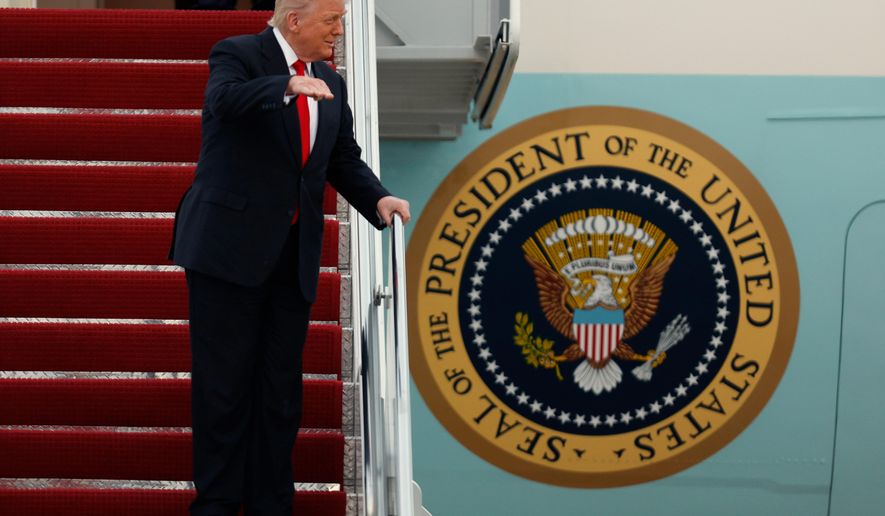 President Donald Trump gestures toward the media as he walks down the stairs of Air Force One upon his arrival at Joint Base Andrews, Md., Sunday, Nov. 9, 2025, after returning from his Mar-a-Lago estate in Palm Beach, Fla. and en route to an NFL football game between the Washington Commanders and the Detroit Lions. (AP Photo/Luis M. Alvarez)