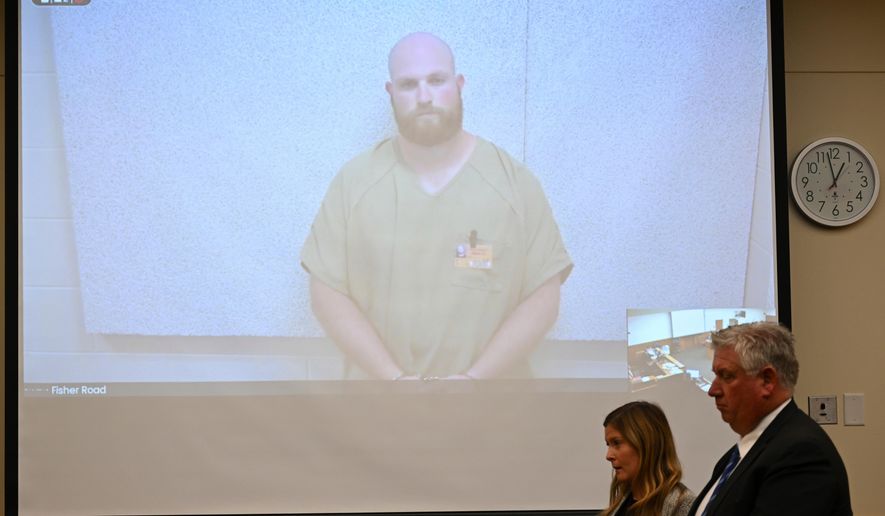FILE - Blendon Township police officer Connor Grubb listens while appearing via video from jail for his arraignment hearing, Aug. 14, 2024, at the Franklin County Court of Common Pleas in Columbus. (AP Photo/David Dermer, File)