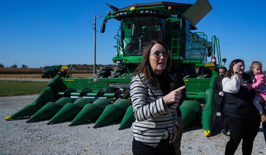 U.S. Secretary of Agriculture Brooke L. Rollins, right, speaks during a farm tour in Lebanon, Ind., Thursday, Oct. 30, 2025. (AP Photo/Michael Conroy)