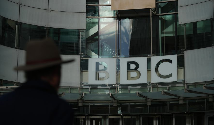 Pedestrian walks outside the BBC Headquarters in London, Wednesday, Nov. 12, 2025. (AP Photo/Kin Cheung)