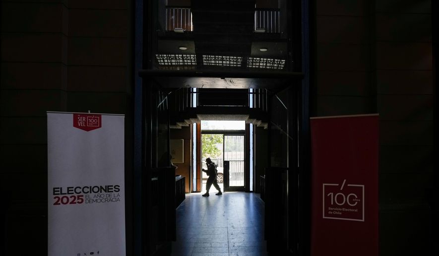 Soldier guard the old Mapocho train station, now a cultural center, that will be used as a polling station for the general election in Santiago, Chile, Friday, Nov. 14, 2025. (AP Photo/Esteban Felix)