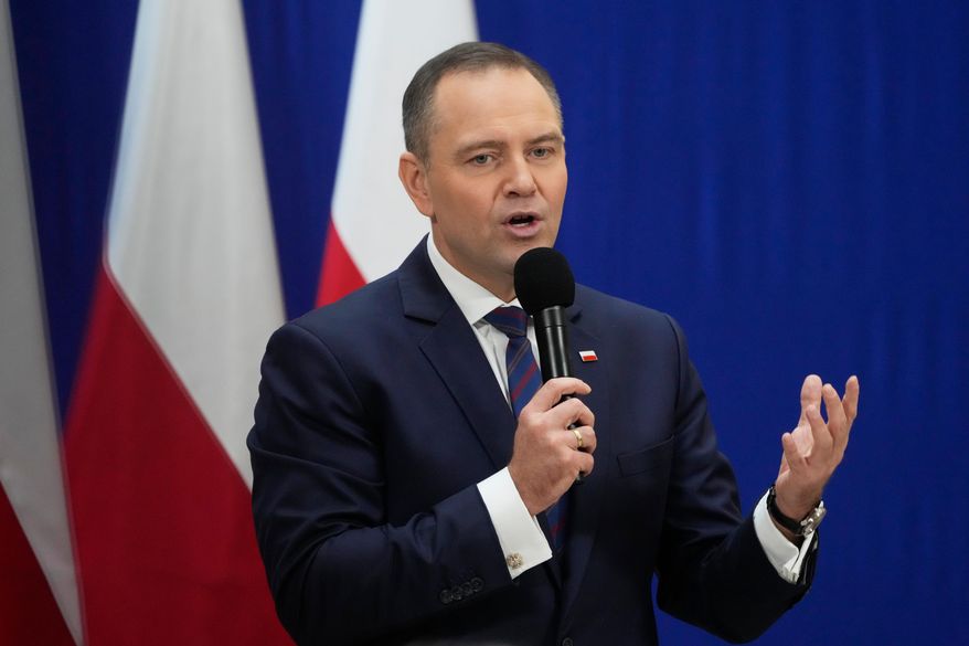 Polish President Karol Nawrocki meets senior citizens and signs a draft law to their benefit during a visit to the public library in Sochaczew, near Warsaw, Poland, Monday, Nov. 3, 2025. (AP Photo/Czarek Sokolowski)