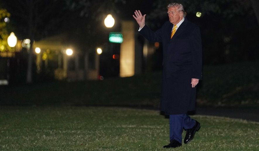 President Donald Trump waves as he walks to board Marine One, Friday, Nov. 14, 2025, on the South Lawn of the White House, in Washington for a trip to Palm Beach, Fla. (AP Photo/Allison Robbert)