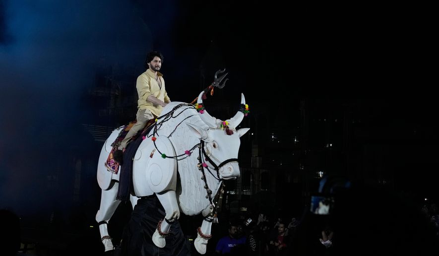 Tollywood superstar Mahesh Babu rides a mechanical bull at the unveiling of first look of film "Varanasi" in Hyderabad, India, Saturday, Nov. 15, 2025. (AP Photo/Mahesh Kumar A.)