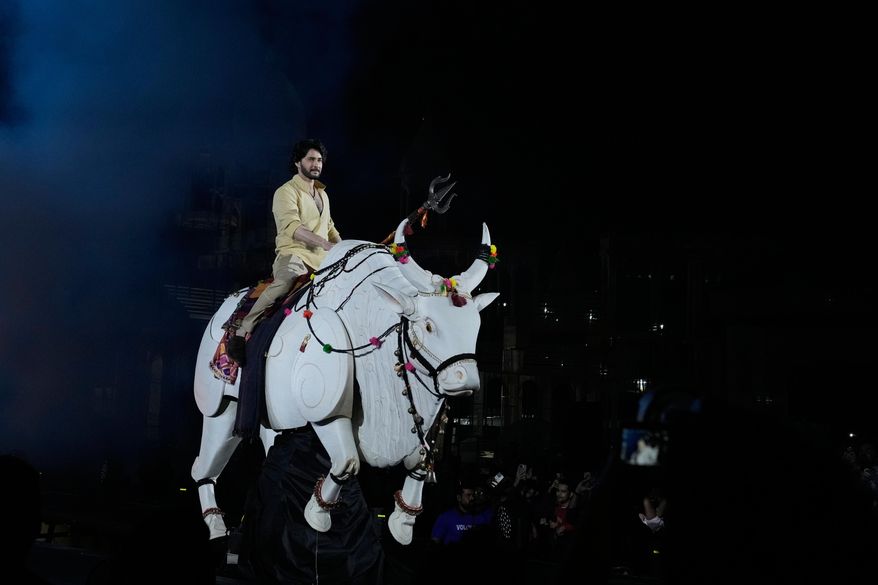 Tollywood superstar Mahesh Babu rides a mechanical bull at the unveiling of first look of film "Varanasi" in Hyderabad, India, Saturday, Nov. 15, 2025. (AP Photo/Mahesh Kumar A.)