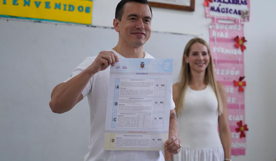 Ecuadorian President Daniel Noboa shows his vote in a referendum on whether to allow foreign military bases in the country and rewrite the constitution through a constituent assembly, in Olon, Ecuador, Sunday, Nov. 16, 2025. (AP Photo/Cesar Munoz)