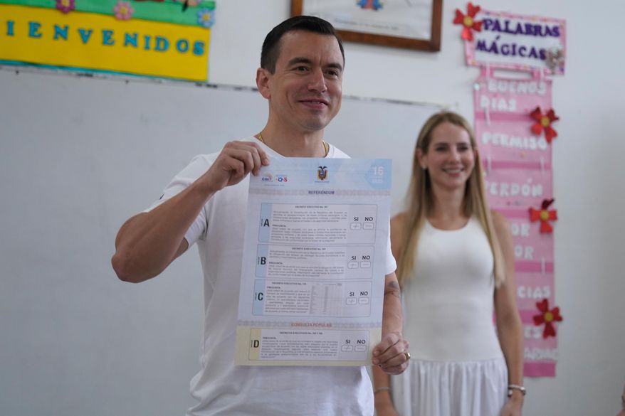 Ecuadorian President Daniel Noboa shows his vote in a referendum on whether to allow foreign military bases in the country and rewrite the constitution through a constituent assembly, in Olon, Ecuador, Sunday, Nov. 16, 2025. (AP Photo/Cesar Munoz)