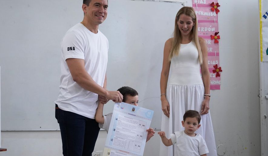 Ecuadorian President Daniel Noboa, accompanied by his family, votes in a referendum on whether to allow foreign military bases in the country and rewrite the constitution through a constituent assembly, in Olon, Ecuador, Sunday, Nov. 16, 2025. (AP Photo/Cesar Munoz)