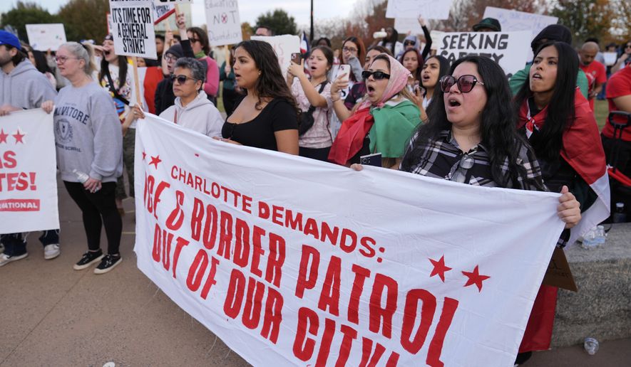 People protest against federal immigration enforcement Saturday, Nov. 15, 2025, in Charlotte, N.C. (AP Photo/Erik Verduzco)