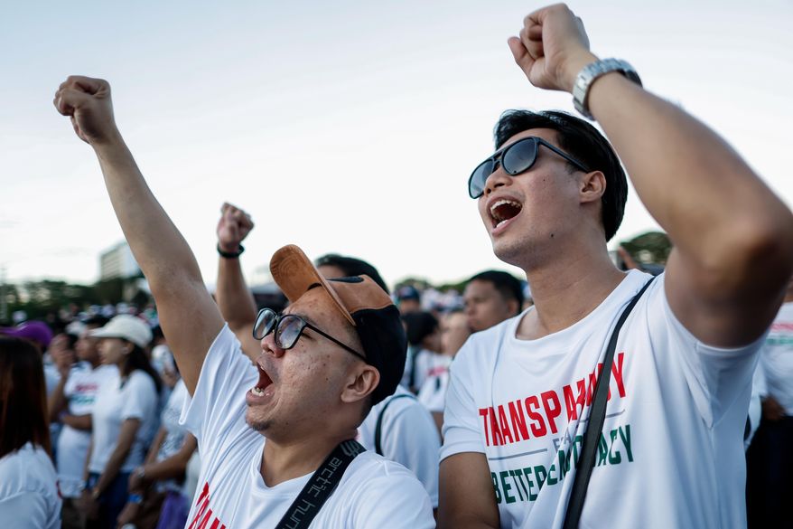 Members of the religious sect Iglesia Ni Cristo (Church of Christ) shout slogans during a three-day anti-corruption rally at Manila's Rizal Park, Philippines on Sunday, Nov. 16, 2025. (AP Photo/Mark Cristino)