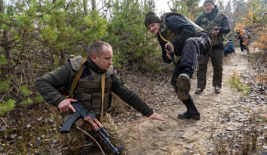 Civilians practice military skills on a training ground in Kharkiv region, Ukraine, Saturday, Nov. 15, 2025. (AP Photo/Andrii Marienko)