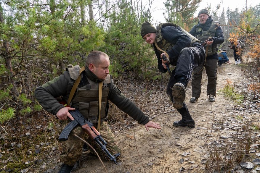 Civilians practice military skills on a training ground in Kharkiv region, Ukraine, Saturday, Nov. 15, 2025. (AP Photo/Andrii Marienko)
