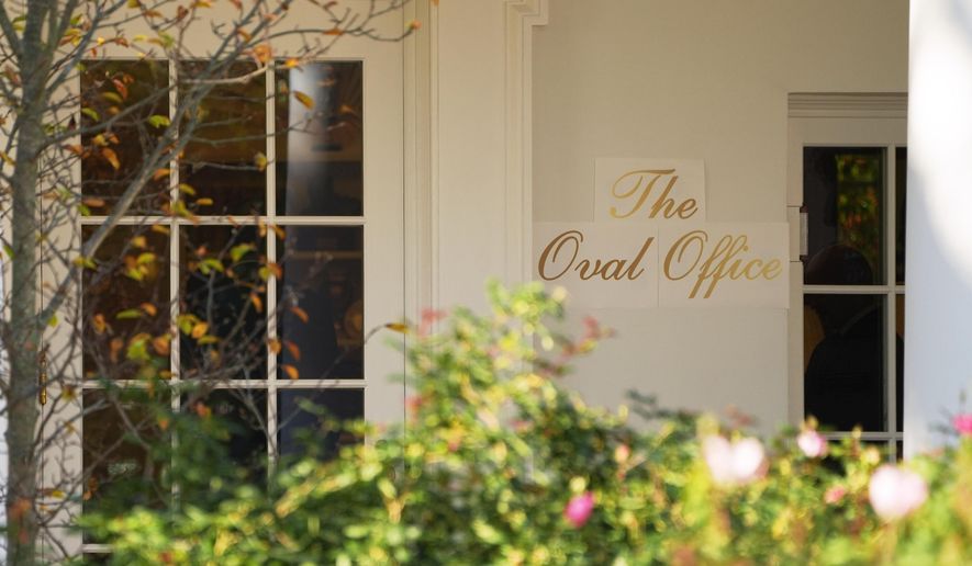 A sign is seen outside the Oval Office before President Donald Trump walks out to board Marine One on the South Lawn of the White House, Wednesday, Nov. 5, 2025, in Washington. (AP Photo/Evan Vucci)