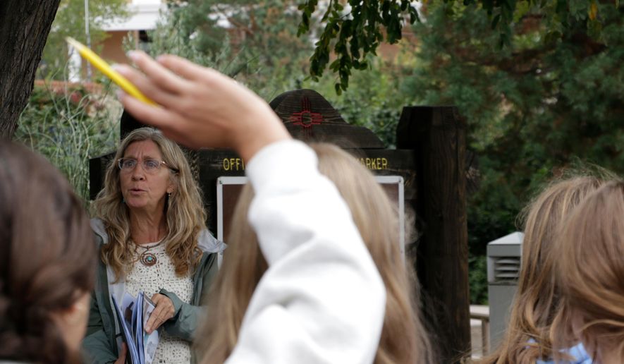 Lisa Nordstrum, a history teacher at Santa Fe Preparatory School, asks questions during a field trip with her seventh-grade history class Wednesday, Oct. 8, 2025, in Santa Fe, N.M. (AP Photo/Stacy Thacker)